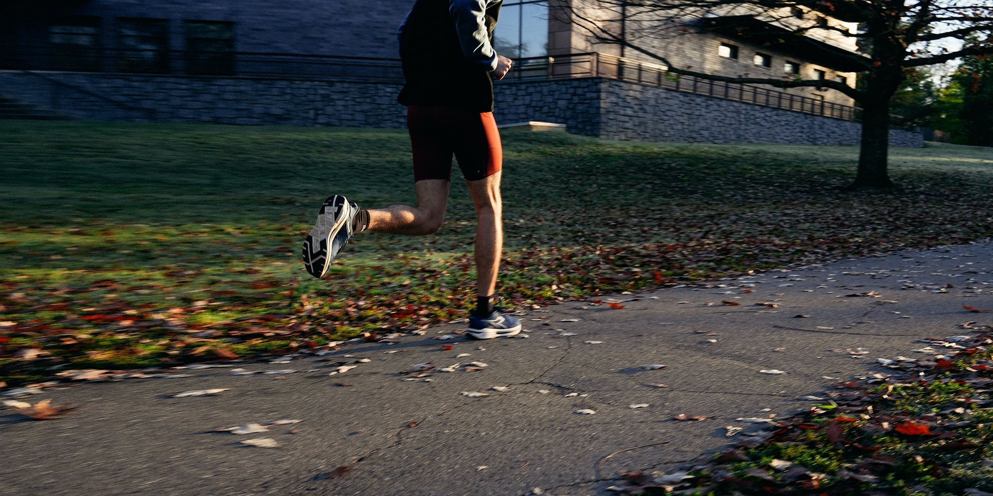 a male runner runs in the park