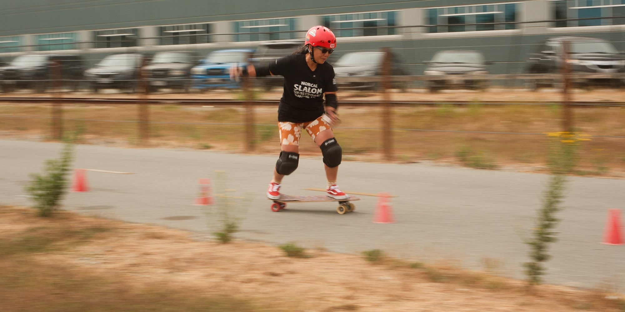 A woman skateboards down a path