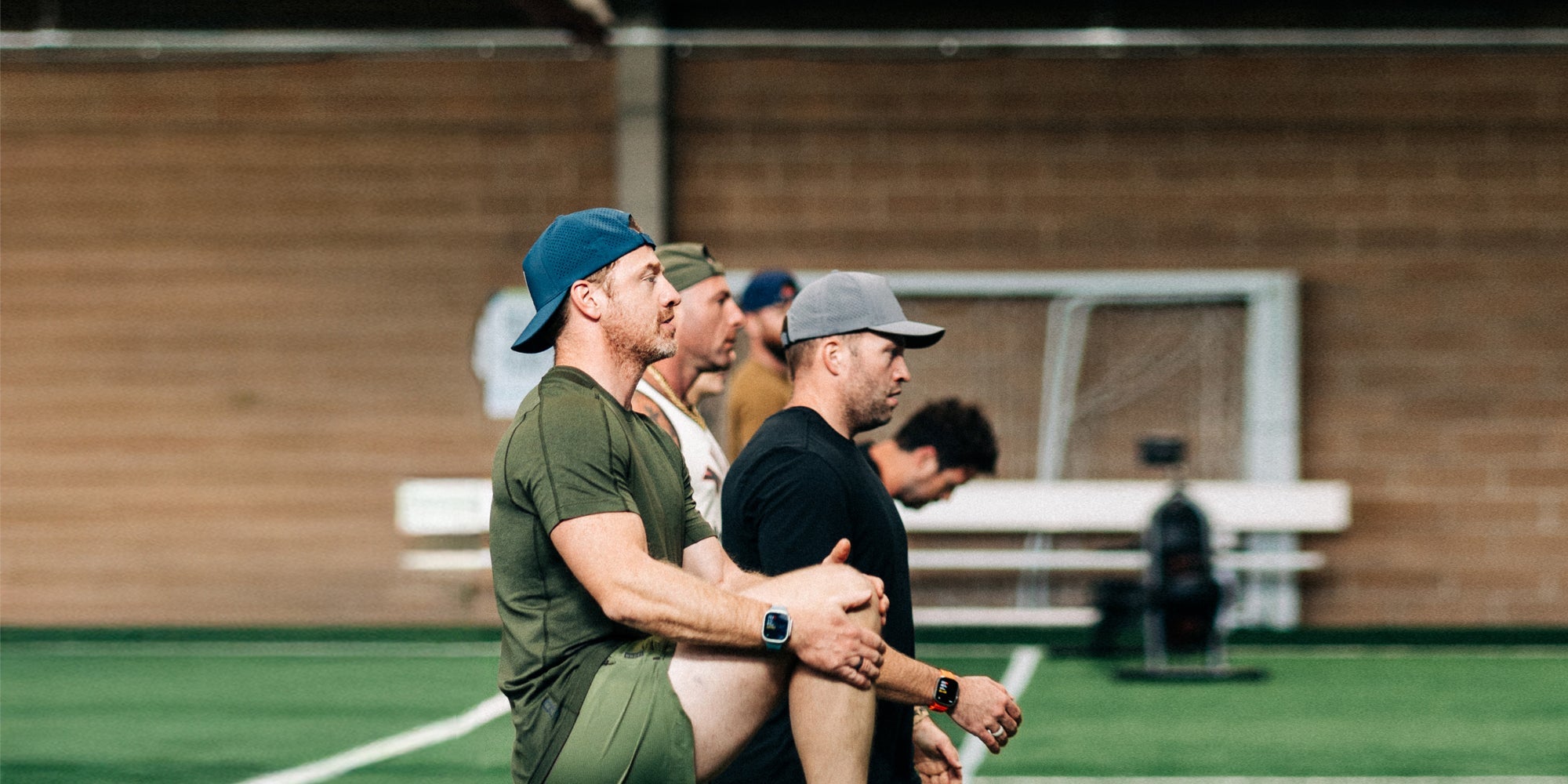 A group of men do a gym workout